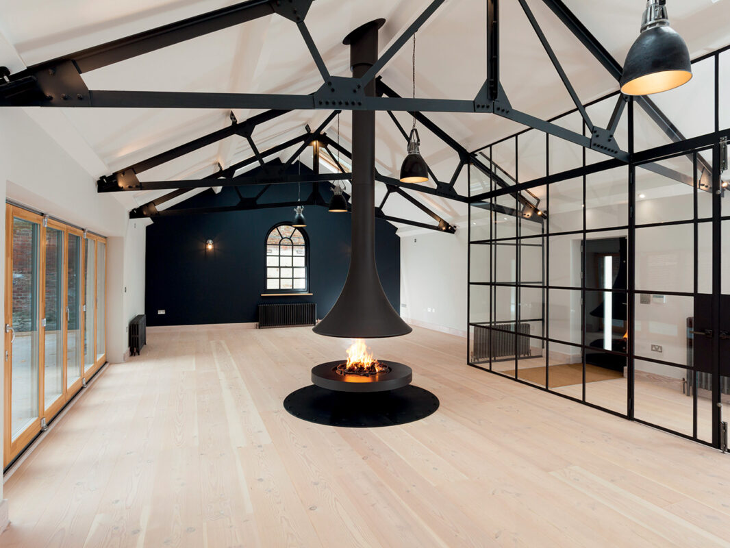 Black JC Bordelet Eva Luxury Suspended Fireplace in a high vaulted ceiling.